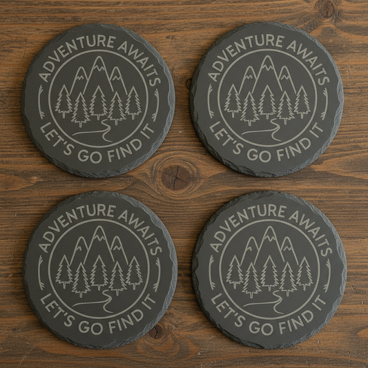 Bring the spirit of the outdoors to your home with this set of four premium slate coasters. Each coaster is laser-engraved with a stunning mountain and pine tree design, paired with the inspiring phrase:
“Adventure Awaits – Let’s Go Find It.”